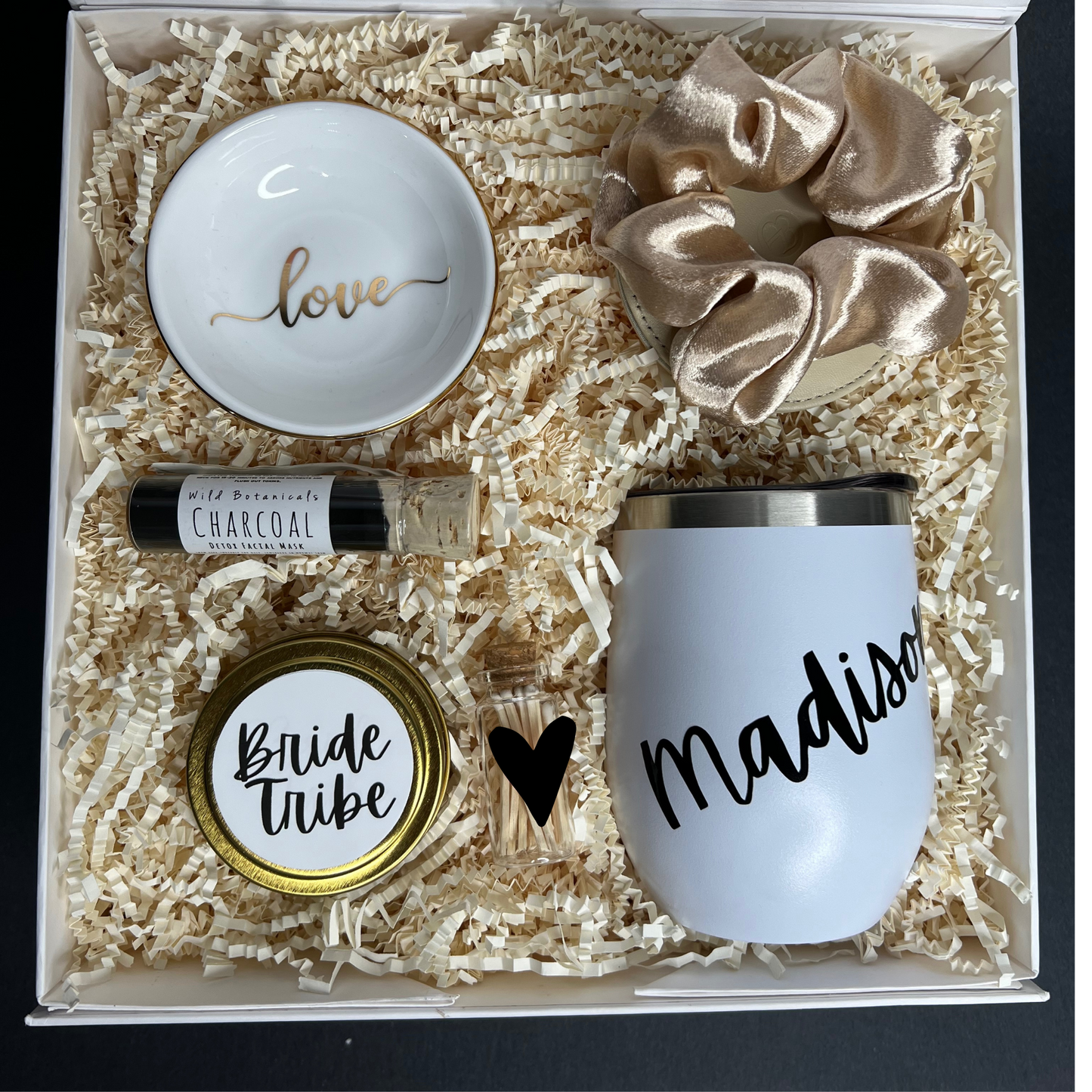 Personalized Bridesmaid Proposal box filled with black, gold and white products. Contains travel size candle with custom sticker, satin scrunchie, charcoal clay face mask, compact mirror, ring dish, personalized 12oz tumbler, match jar with striker.